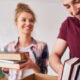 couple packing several books to donate