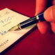 writing a cheque for donation