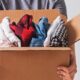 man handing clothes in a box