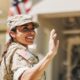 a military woman waving to military veterans