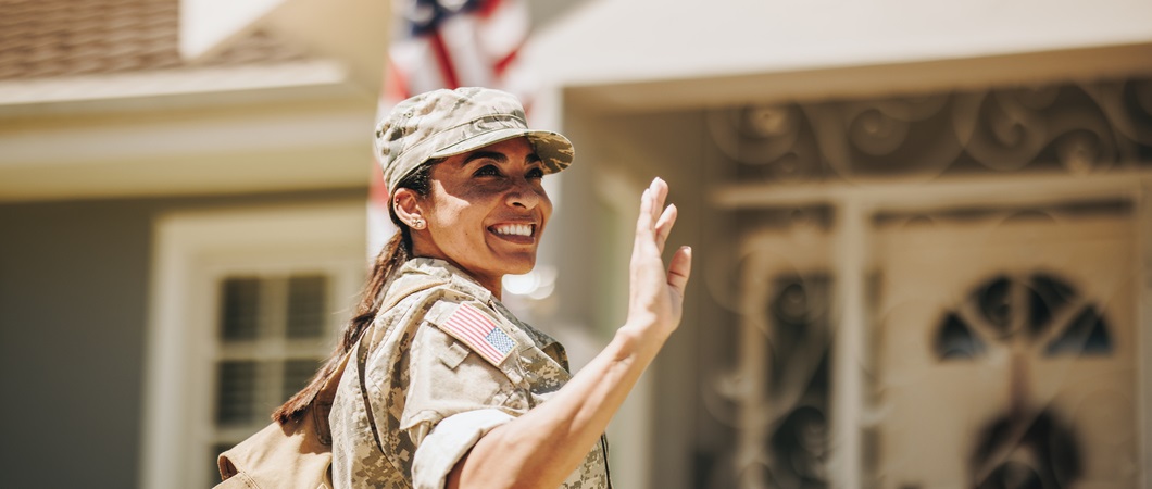 a military woman waving to military veterans