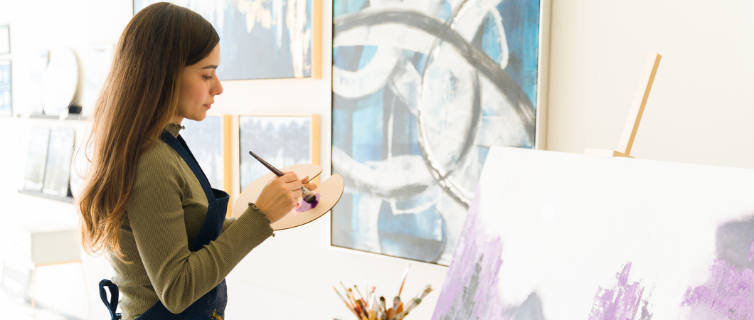 woman painting an artwork for a charity