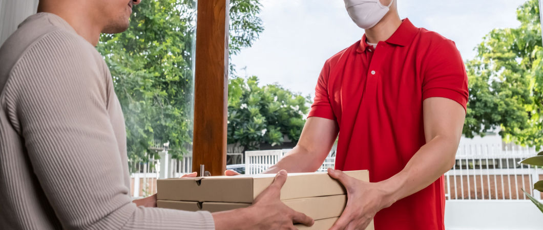 man giving pizza to their movers