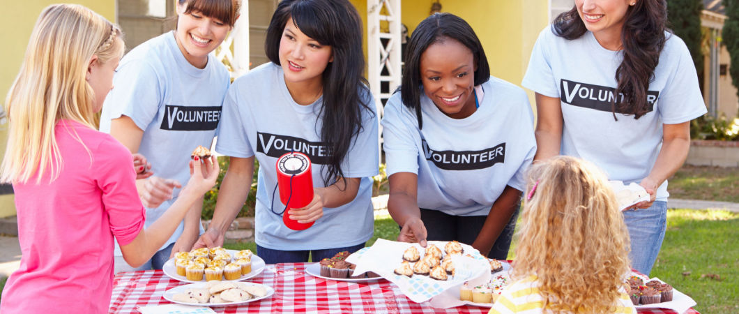 volunteer women running non profit bake sale
