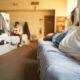 men lying on beds in homeless shelter