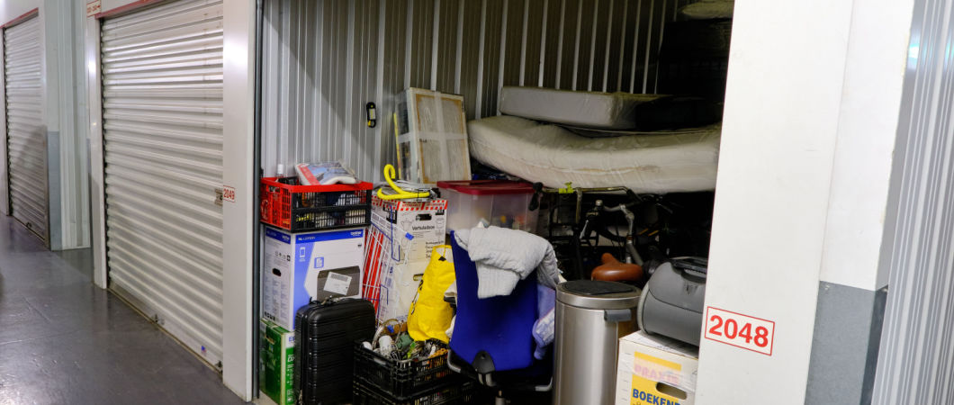 indoor storage unit with open door and household goods