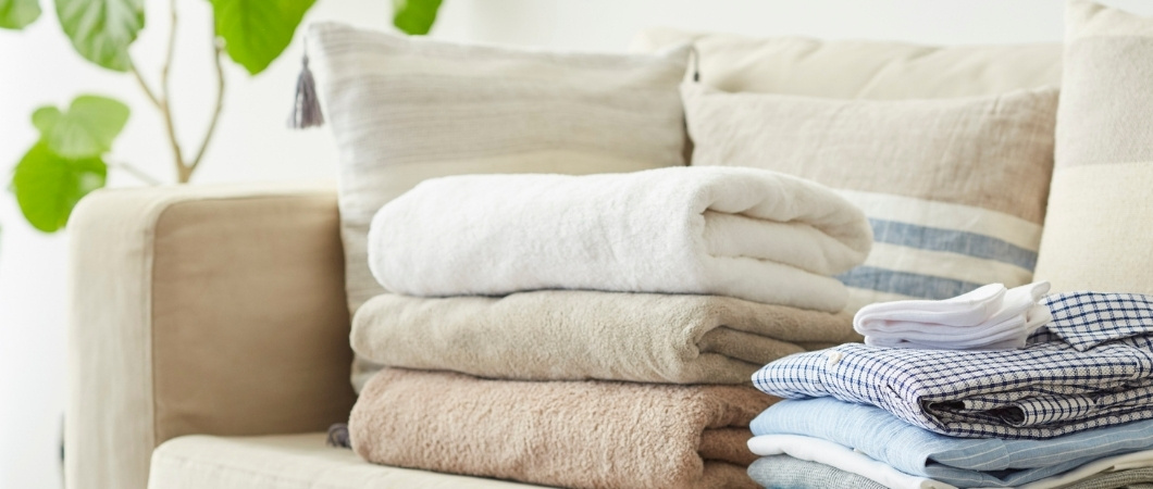 clothing and towels in the sofa