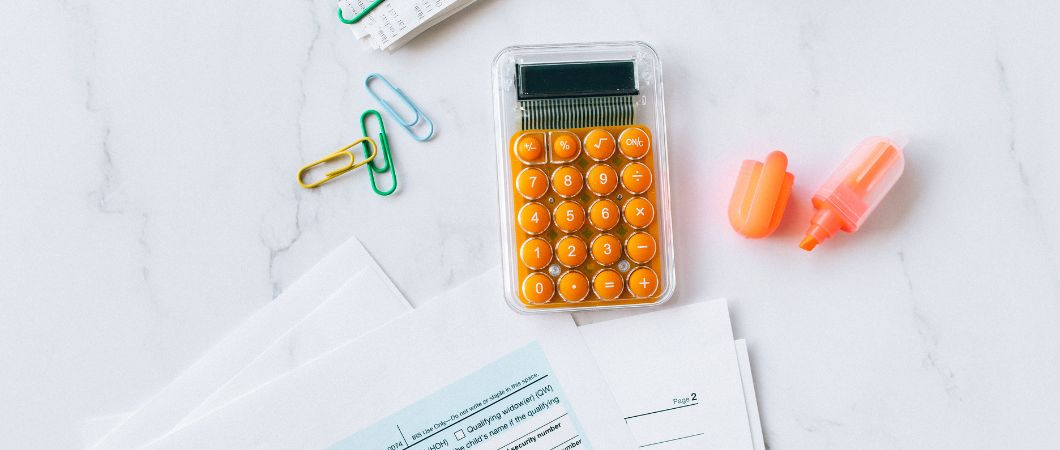 calculator with paper clips and documents