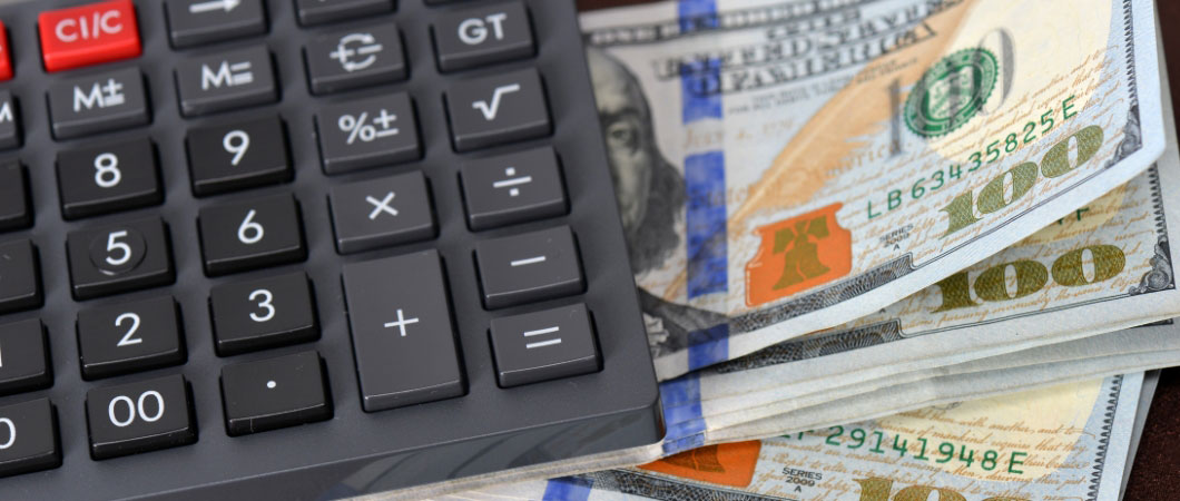 one hundred dollar bills and black calculator