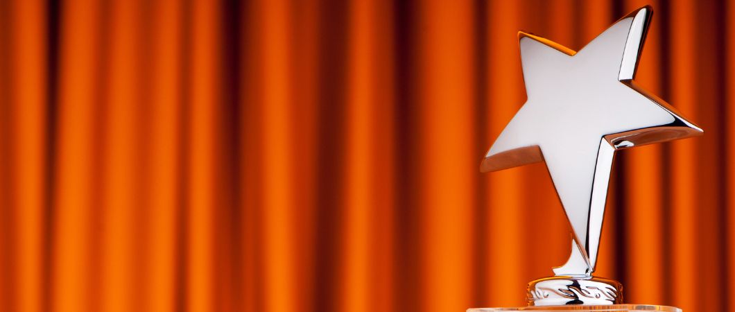star award with orange curtain on the background