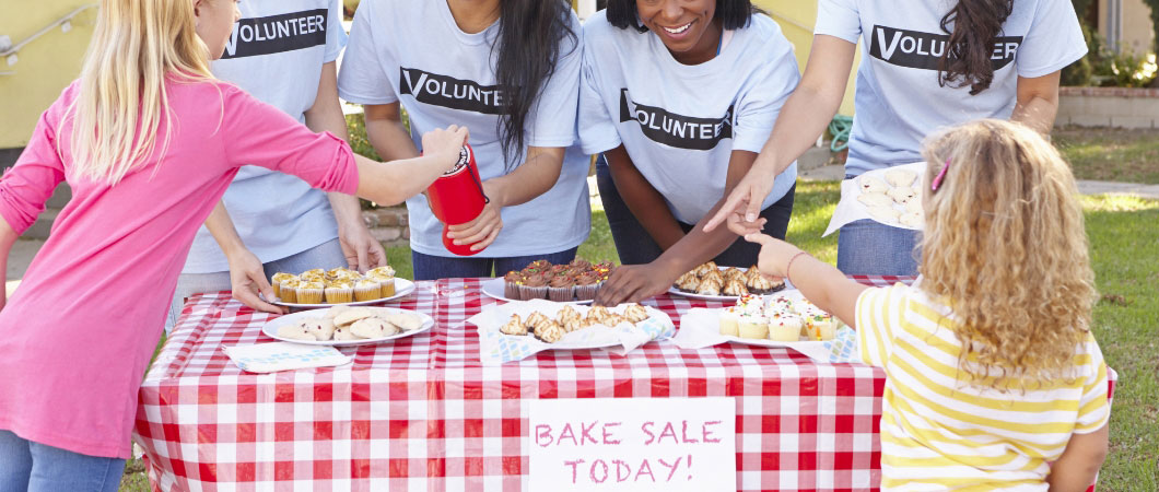women and children running a charity bake sale