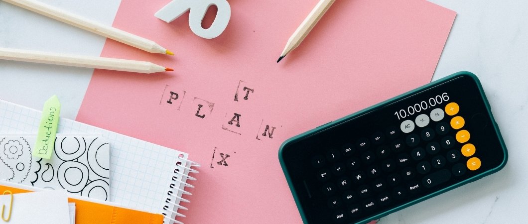 calculator notebook and pencil for a tax plan