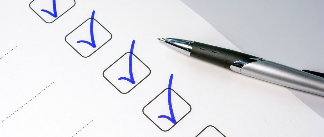 pen and paper with blue check