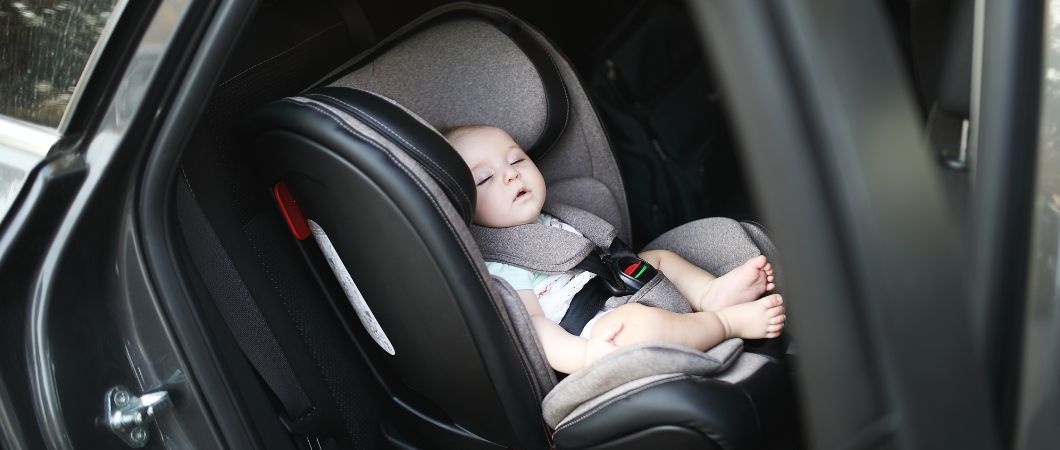baby sleeping in car safety seat while they are moving
