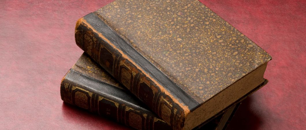 antique books on red flat surface