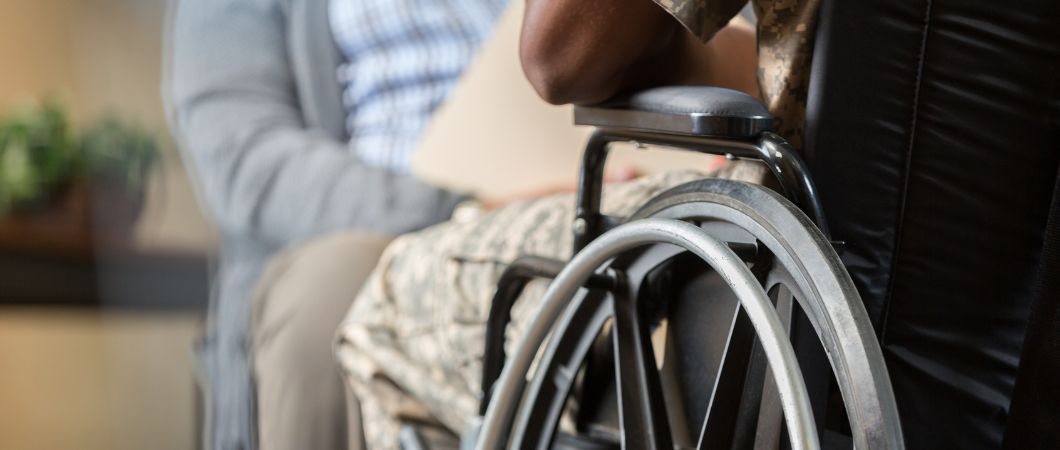 injured veteran talks with charity personnel