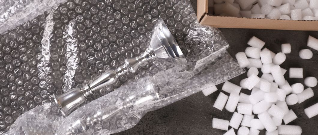 silver candlesticks bubble wrap and styrofoam packing peanuts