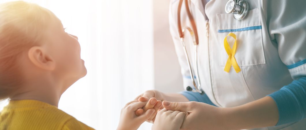 volunteer doctor holding hands with her child patient