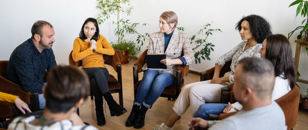 group of people talking about the charity they will choose