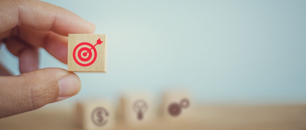 hand chooses block with target symbol on blurred background