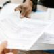 man handing out documents for donation tax deduction