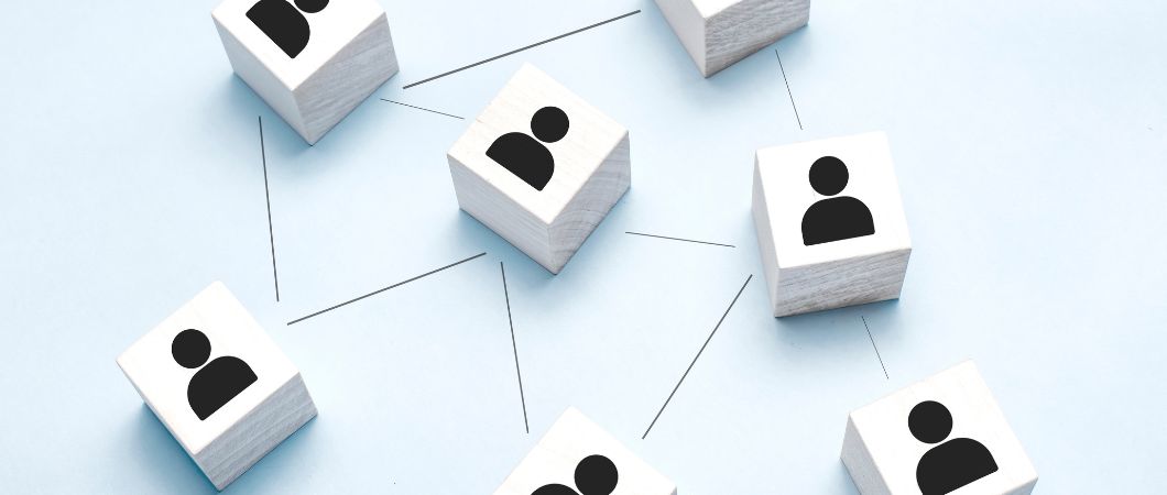 person icon on wooden cubes linked to each other