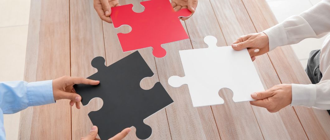 team holding mismatched puzzle pieces