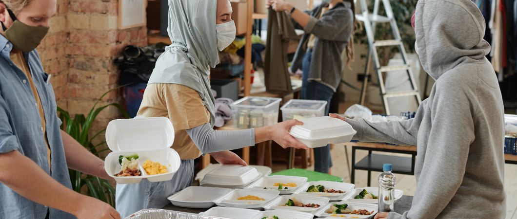 volunteers wearing face mask giving food