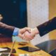 man in suits shaking hands making deal of sponsorship in charity