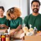 happy volunteers packing food in donation box
