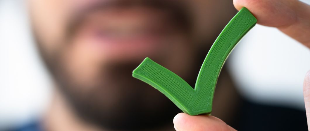 man holding green check sign