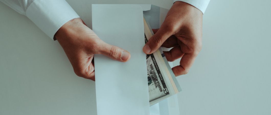 man putting bunch of dollars tip for movers