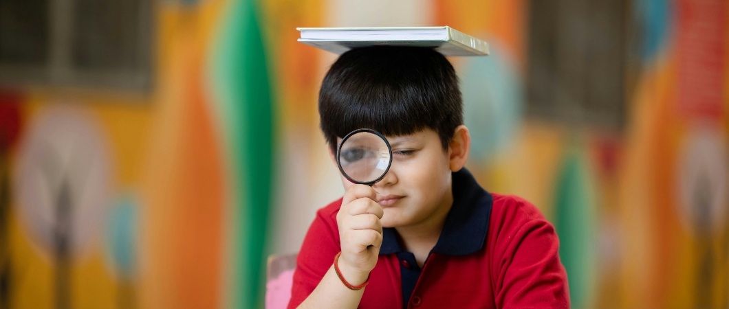 boy looking at magnifying glass
