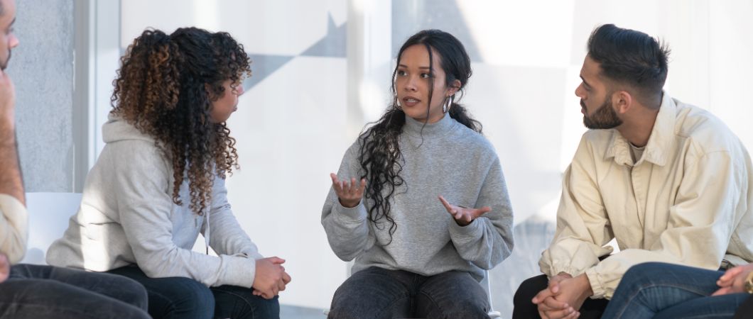 female volunteer sharing during group counseling