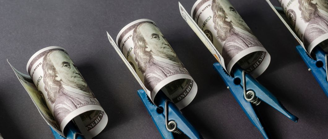 one hundred dollar bills rolled separately