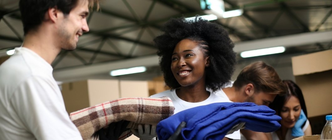 charity volunteers packing clothes and old glasses