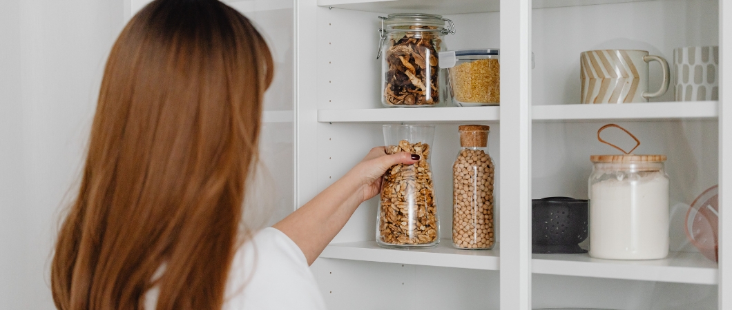 woman organizing and decluttering pantry